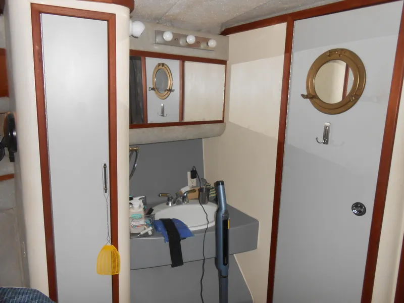 Slide: The Image of 1988 Cruisers Yachts 4280 Express Bridge bathroom with sink and storage cabinets. - 20