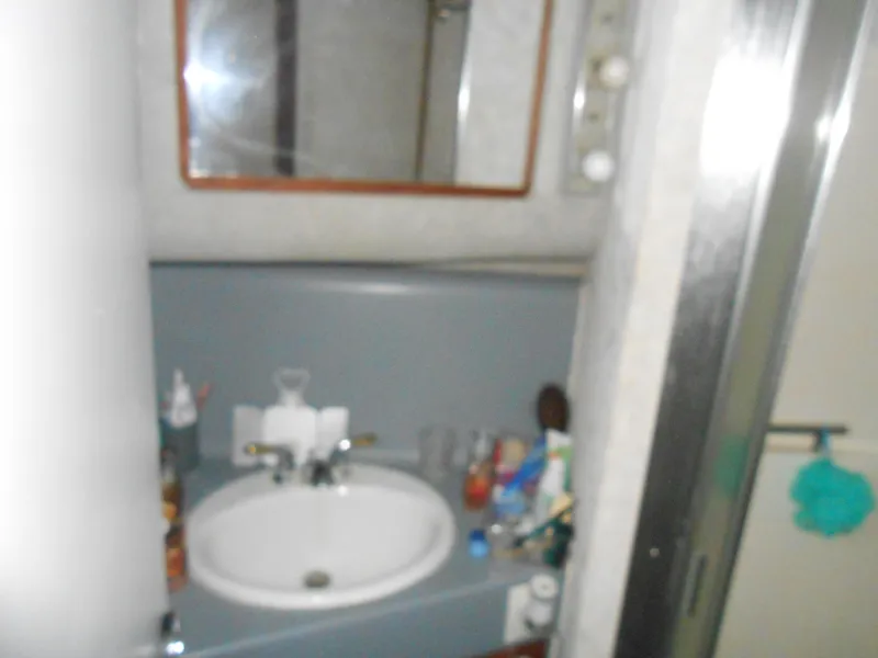 Slide: The Image of Bathroom sink area in 1988 Cruisers Yachts 4280 Express Bridge. - 24