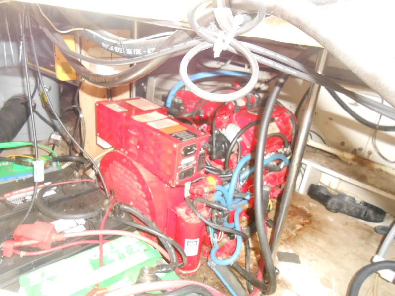 Slide: The Image of Engine compartment of a 1988 Cruisers Yachts 4280 Express Bridge with wiring and components. - 28