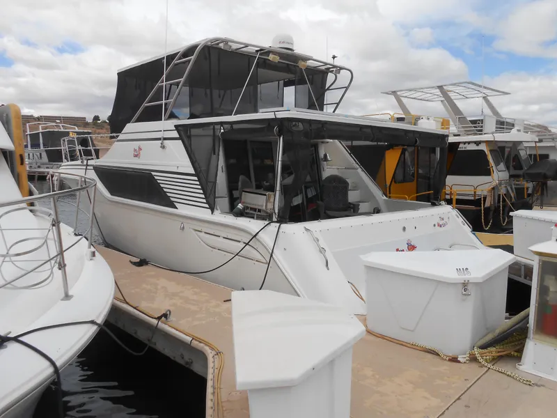 Slide: The Image of 1988 Cruisers Yachts 4280 Express Bridge docked at marina. - 3