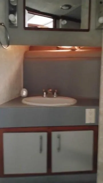 Slide: The Image of 1988 Cruisers Yachts 4280 Express Bridge bathroom vanity with sink and mirror. - 30