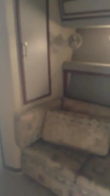 Slide: The Image of Interior of 1988 Cruisers Yachts 4280 Express Bridge with cushioned seating and storage. - 32