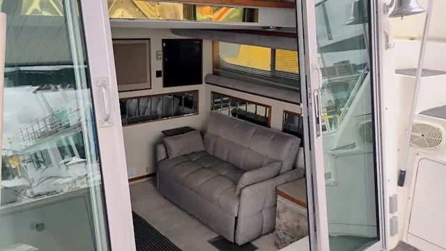 Slide: The Image of 1988 Cruisers Yachts 4280 Express Bridge interior with sofa and sliding glass doors. - 33