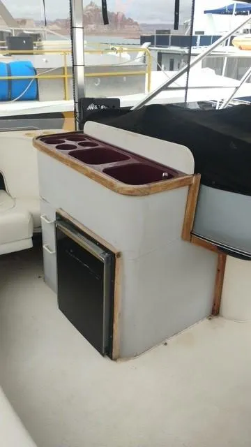 Slide: The Image of 1988 Cruisers Yachts 4280 Express Bridge interior with mini fridge and storage compartments. - 35