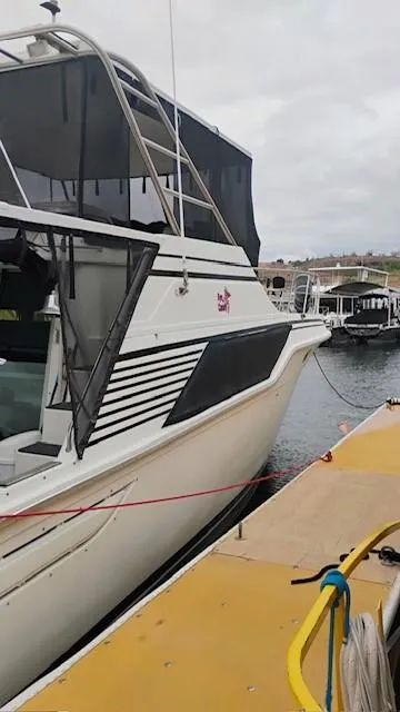 Slide: The Image of 1988 Cruisers Yachts 4280 Express Bridge docked at marina, side view. - 36