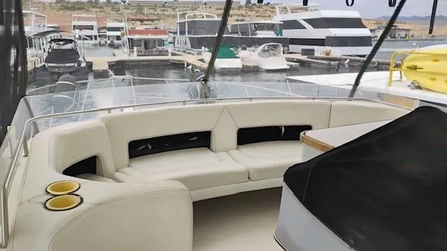 Slide: The Image of 1988 Cruisers Yachts 4280 Express Bridge with spacious seating, docked at a marina. - 37