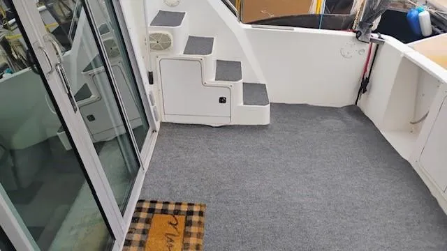 Slide: The Image of 1988 Cruisers Yachts 4280 Express Bridge interior with carpeted deck and stairs. - 38