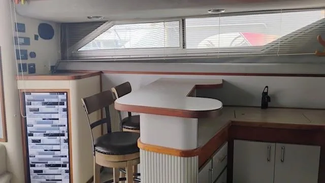 Slide: The Image of Interior of 1988 Cruisers Yachts 4280 Express Bridge with bar and seating area. - 40