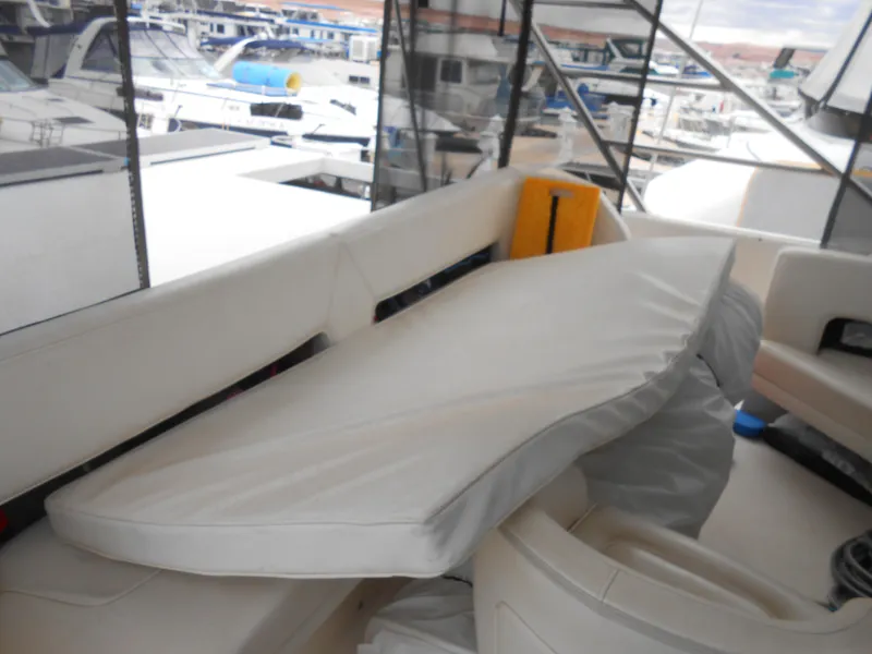 Slide: The Image of 1988 Cruisers Yachts 4280 Express Bridge interior with covered seating area. - 7