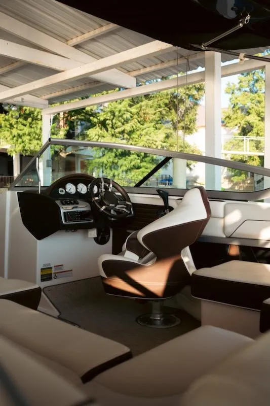 Slide: The Image of 2016 Regal 2100 Bowrider interior with steering wheel and seating under canopy. - 15