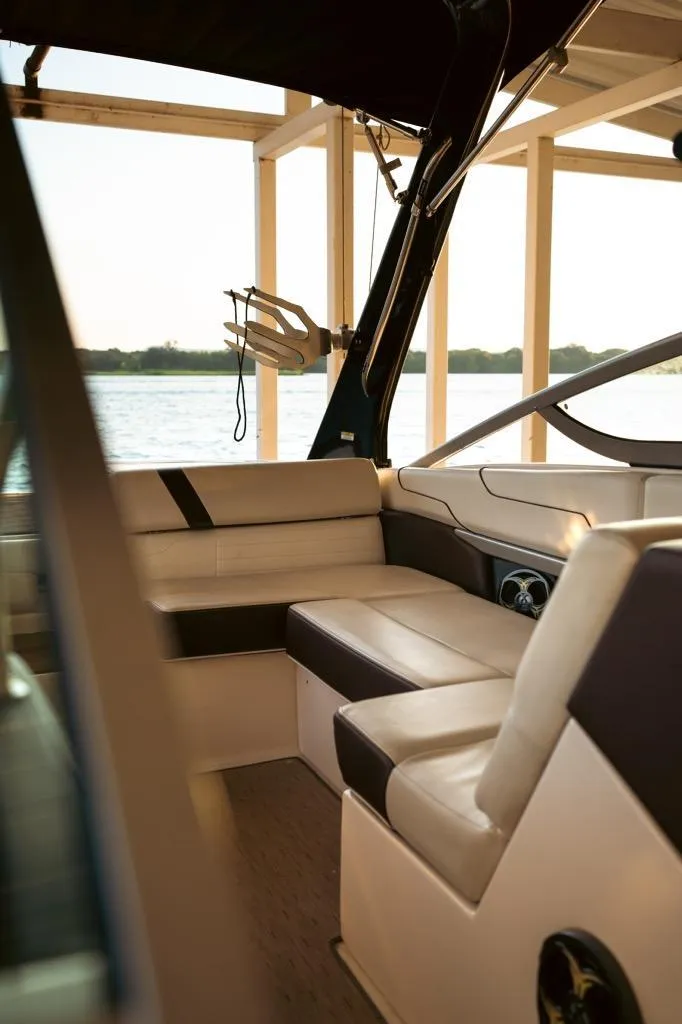 Slide: The Image of Interior of 2016 Regal 2100 Bowrider boat with beige seating and lake view. - 22