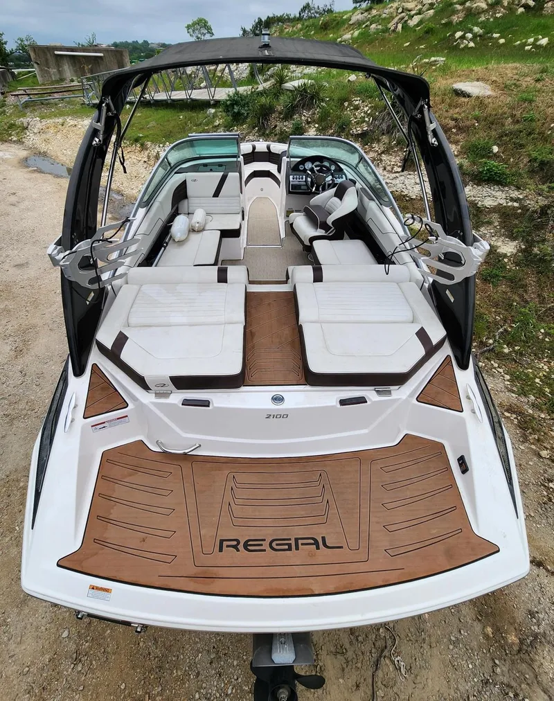 Slide: The Image of 2016 Regal 2100 Bowrider boat with spacious seating and sleek design. - 4