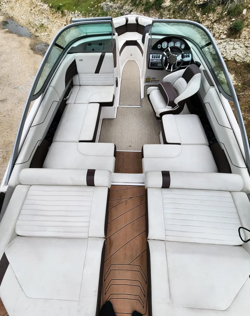 Slide: The Image of 2016 Regal 2100 Bowrider interior with white and brown seating, wood flooring. - 5