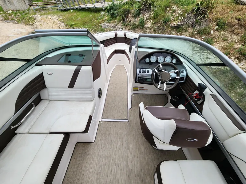 Slide: The Image of Interior of a 2016 Regal 2100 Bowrider boat with seating and steering console. - 7
