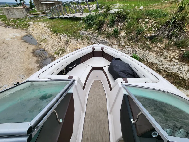 Slide: The Image of 2016 Regal 2100 Bowrider boat interior with open windshield and seating area. - 8