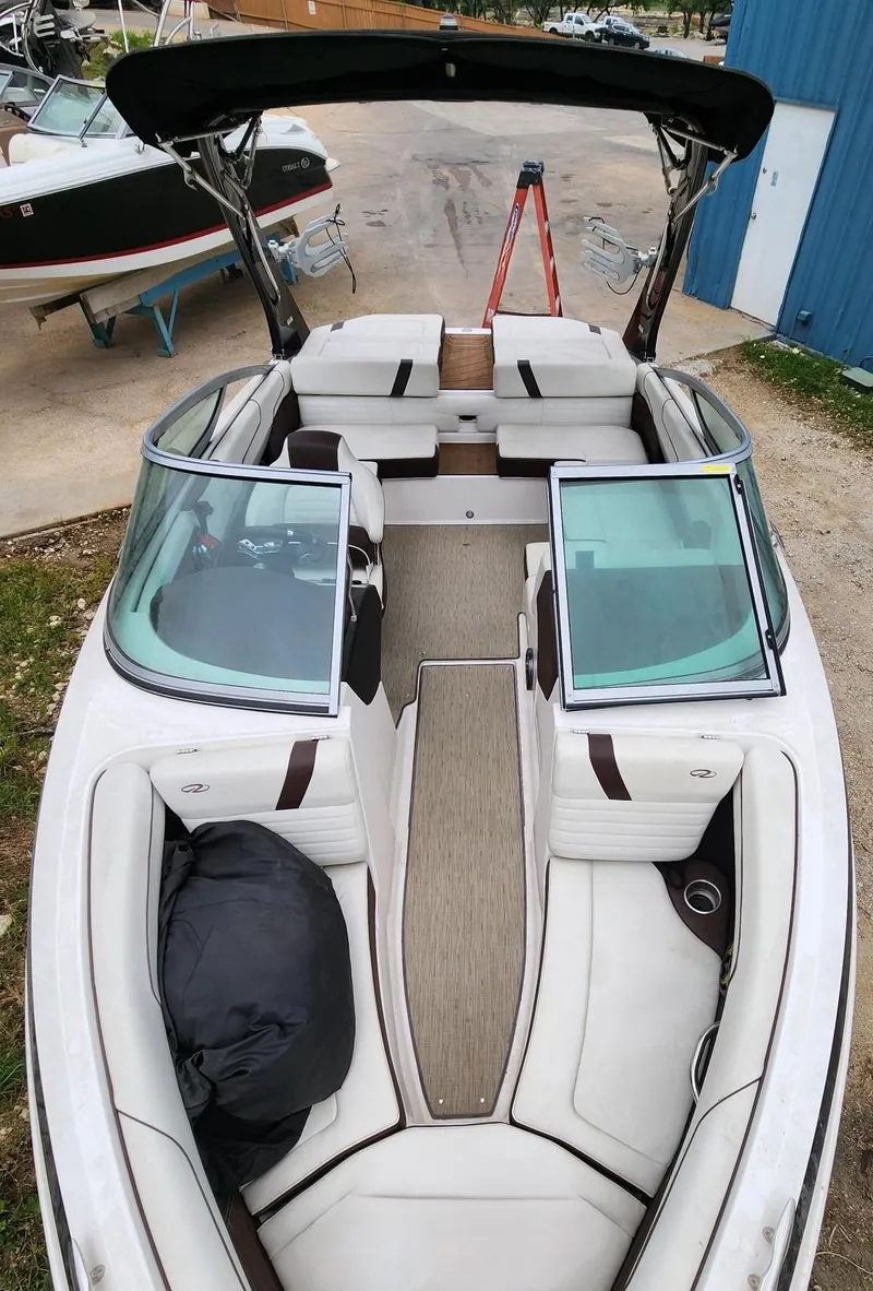 Slide: The Image of 2016 Regal 2100 Bowrider boat with spacious seating and modern design. - 9