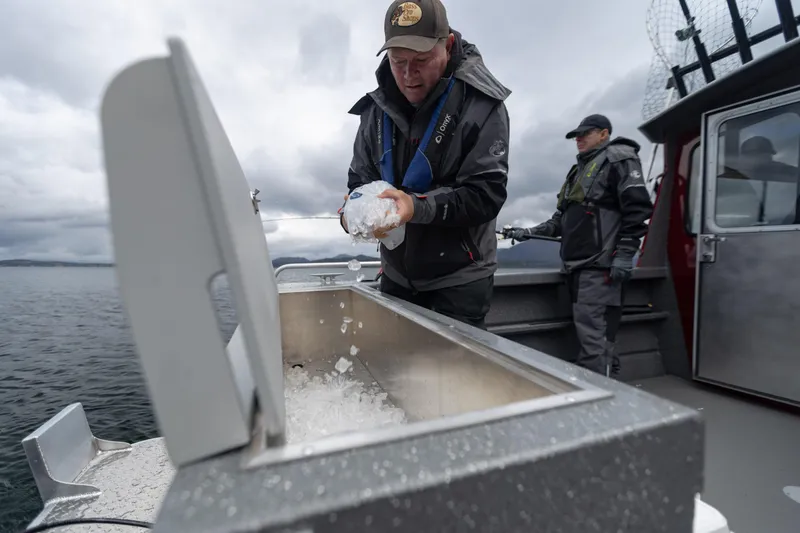 Slide: The Image of Two people on a 2024 Spartan 240 Maximus Pro boat handling ice. - 17