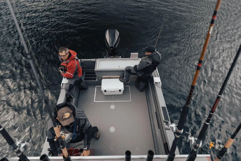 Slide: The Image of Three people fishing on a 2024 Spartan 240 Maximus Pro boat. - 4