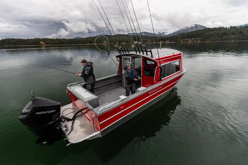 Slide: The Image of 2024 Spartan 240 Maximus Pro boat on a lake with two people fishing. - 6
