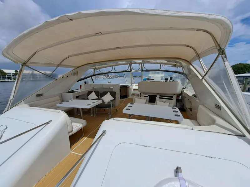 Slide: The Image of 1984 Infinity Express boat with spacious seating and dining area under canopy. - 10