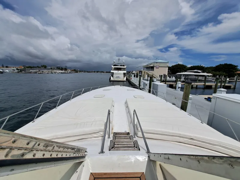 Slide: The Image of View from the bow of a 1984 Infinity Express yacht docked at a marina. - 12