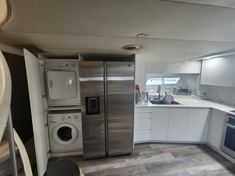 Slide: The Image of Modern kitchen in 1984 Infinity Express with washer, dryer, and stainless steel refrigerator. - 15