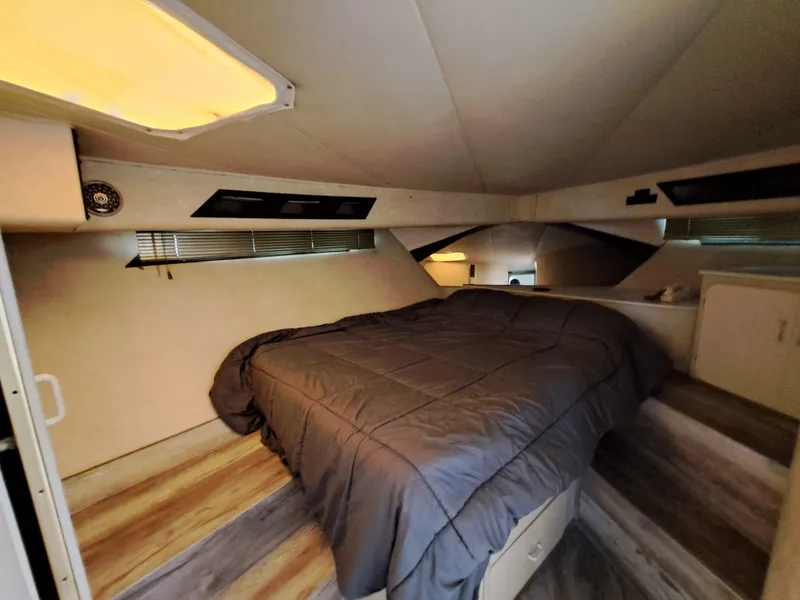 Slide: The Image of 1984 Infinity Express RV interior bedroom with cozy bed and ambient lighting. - 18