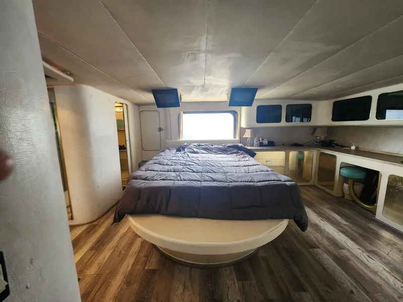Slide: The Image of 1984 Infinity Express RV interior with a cozy bedroom setup and modern amenities. - 19