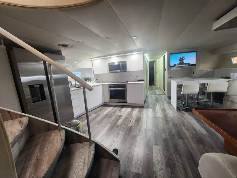 Slide: The Image of Modern kitchen and living area inside a 1984 Infinity Express yacht. - 2