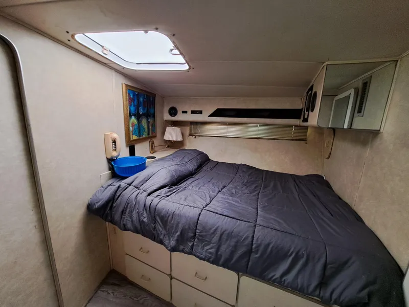 Slide: The Image of Cozy bedroom in 1984 Infinity Express RV with skylight and storage drawers. - 21