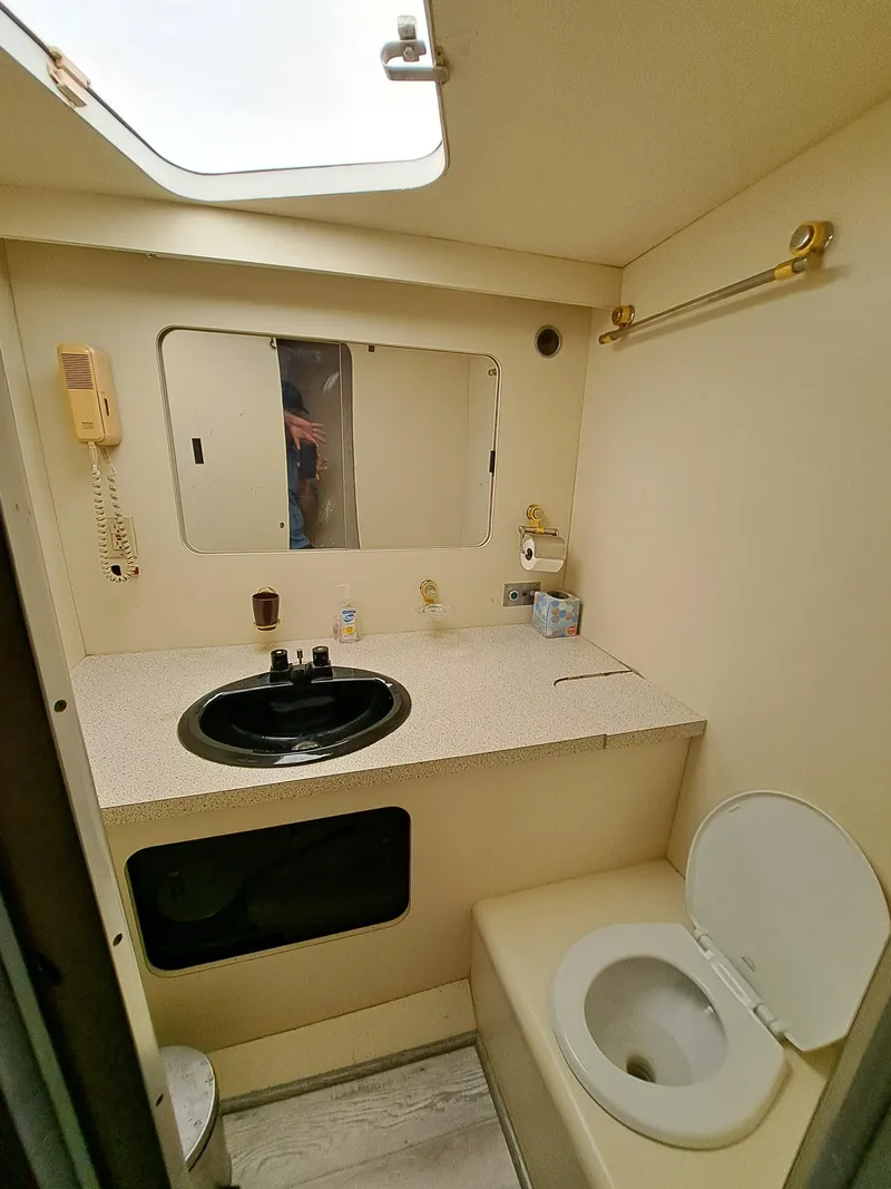 Slide: The Image of 1984 Infinity Express bathroom with sink, toilet, and mirror. - 24