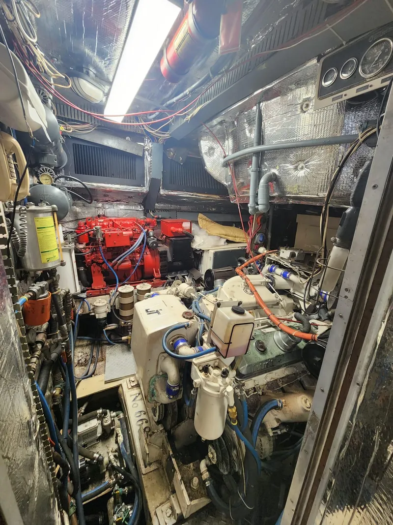 Slide: The Image of Engine room of a 1984 Infinity Express boat with complex machinery and wiring. - 27