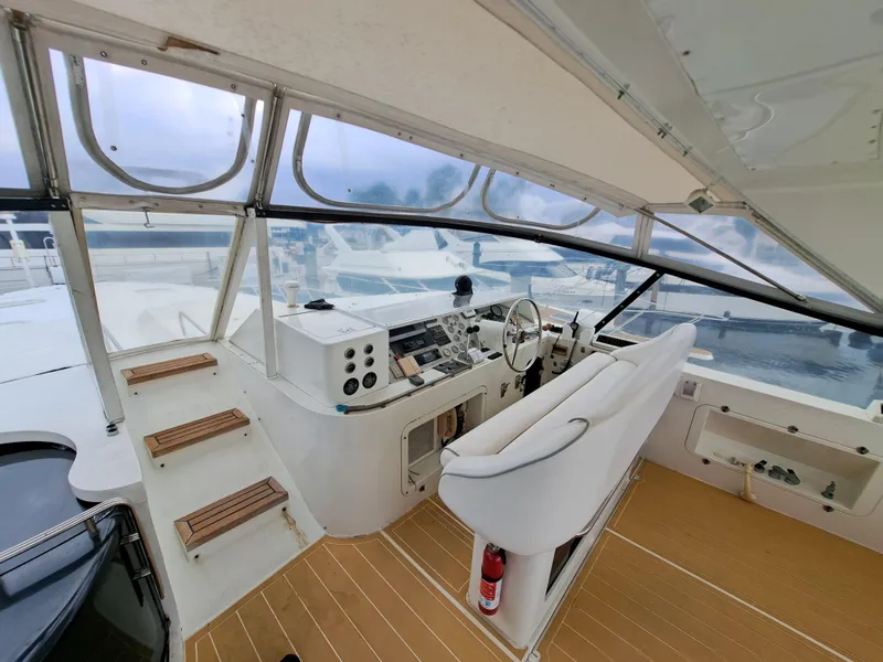 Slide: The Image of 1984 Infinity Express boat cockpit with steering wheel and control panel. - 6