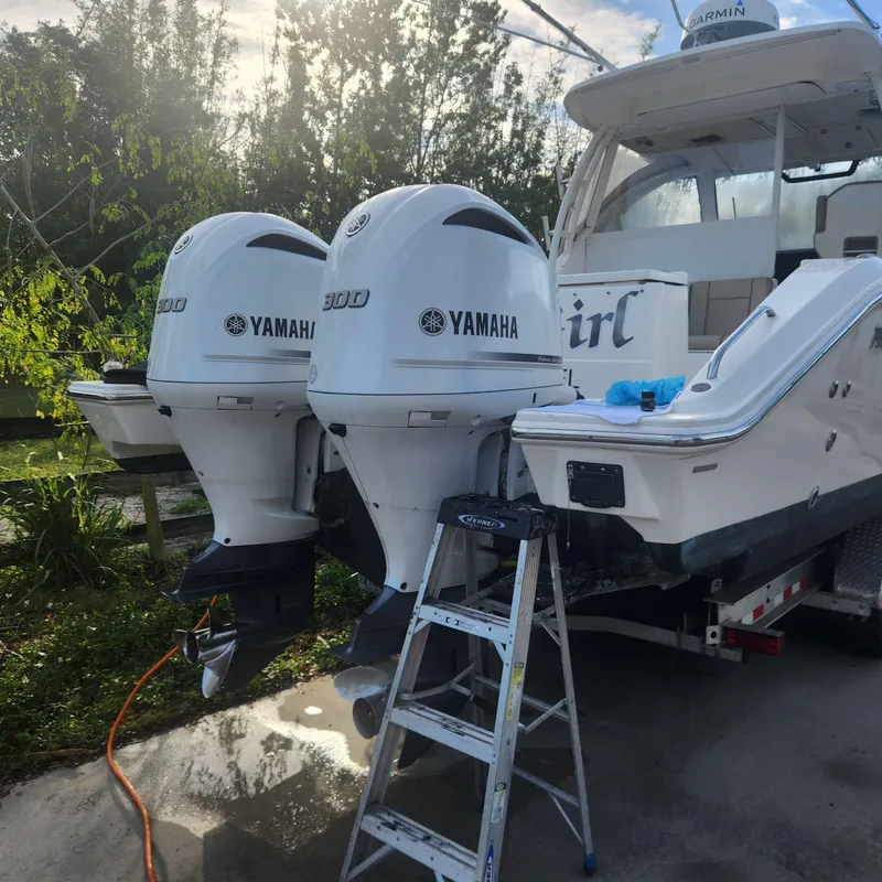 Slide: The Image of 2020 Pursuit OS 325 Offshore boat with twin Yamaha 300 engines on trailer. - 12