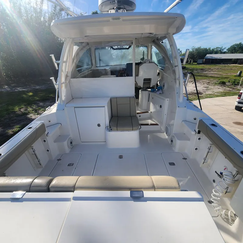 Slide: The Image of 2020 Pursuit OS 325 Offshore boat interior with seating and helm station. - 14