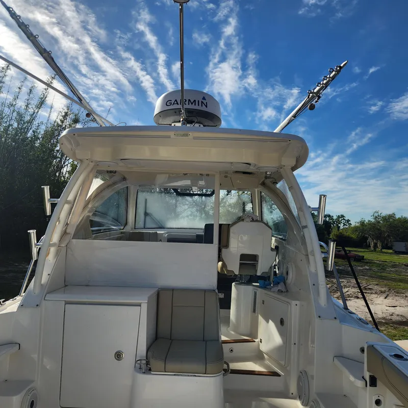Slide: The Image of 2020 Pursuit OS 325 Offshore boat interior with Garmin radar under a clear sky. - 21