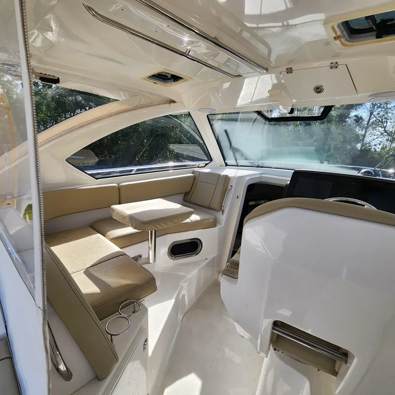 Slide: The Image of Interior of 2020 Pursuit OS 325 Offshore boat with seating and table. - 25