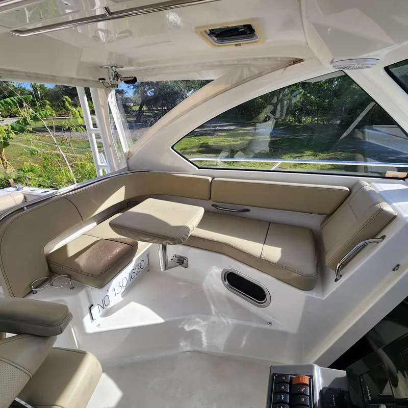 Slide: The Image of Interior of 2020 Pursuit OS 325 Offshore boat with beige seating and table. - 26