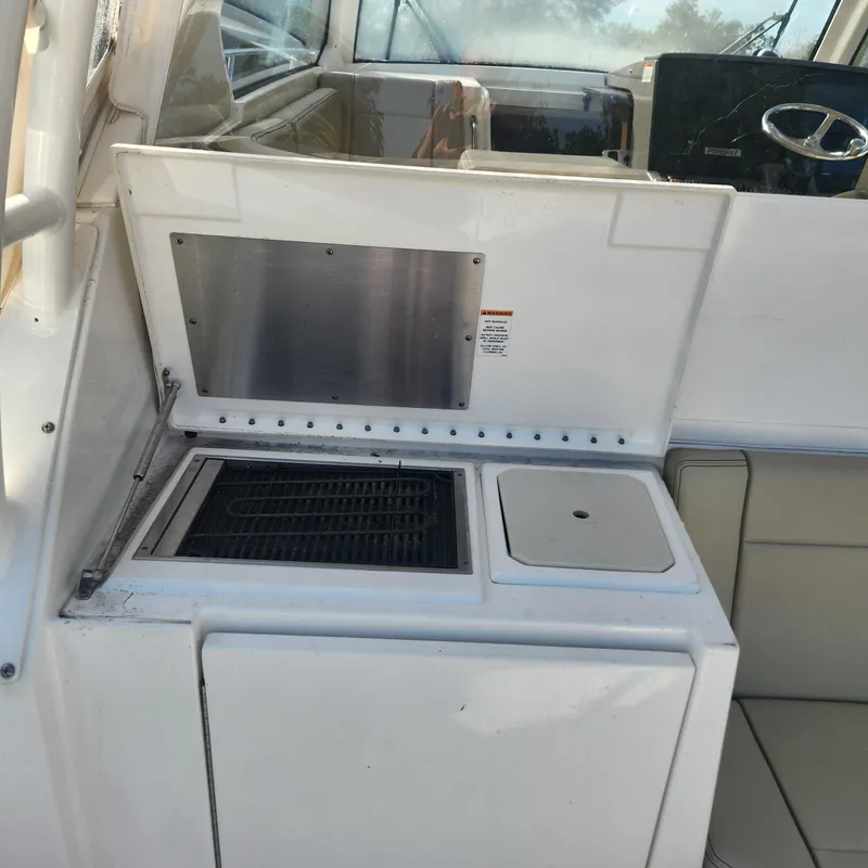 Slide: The Image of Outdoor kitchen area on a 2020 Pursuit OS 325 Offshore boat. - 27