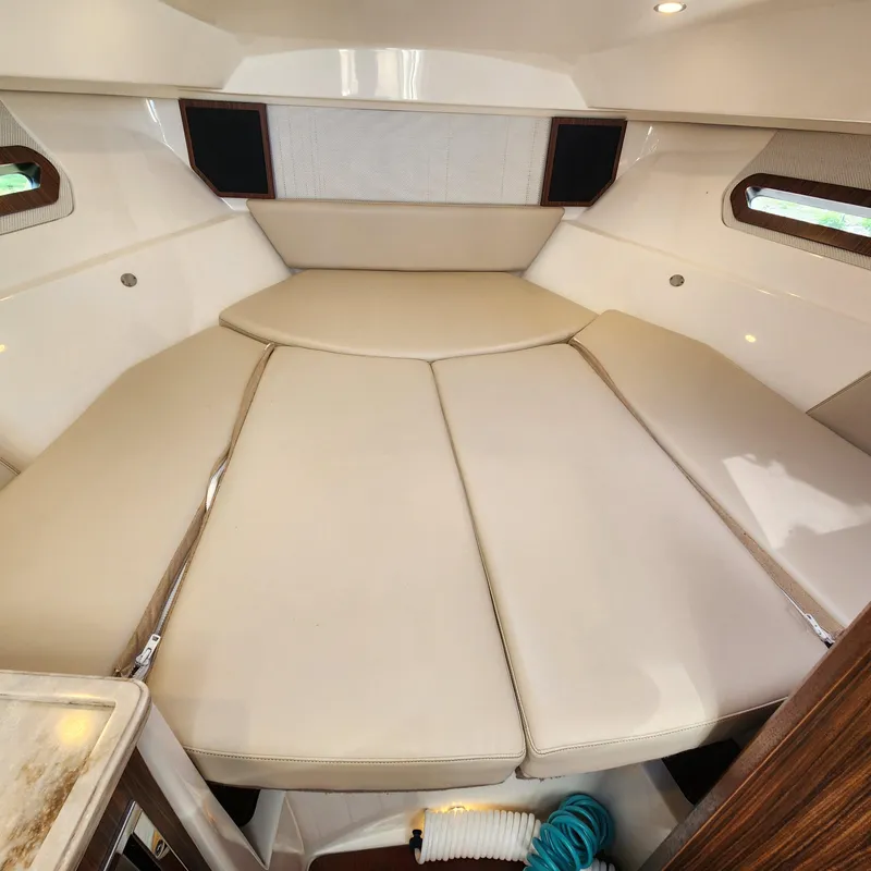 Slide: The Image of Interior cabin of 2020 Pursuit OS 325 Offshore boat with beige cushions. - 30