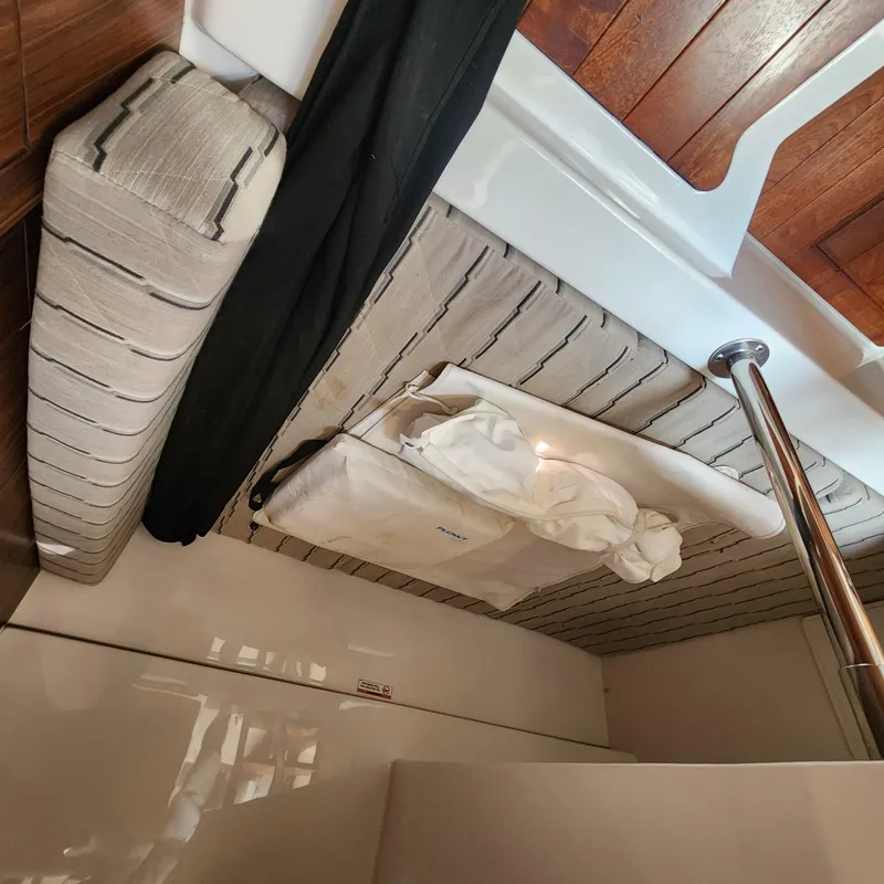 Slide: The Image of Interior cabin of 2020 Pursuit OS 325 Offshore boat with cushioned seating and wooden flooring. - 34