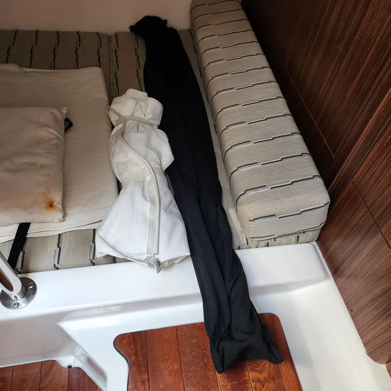 Slide: The Image of Interior cabin of a 2020 Pursuit OS 325 Offshore boat with cushions and clothing. - 35