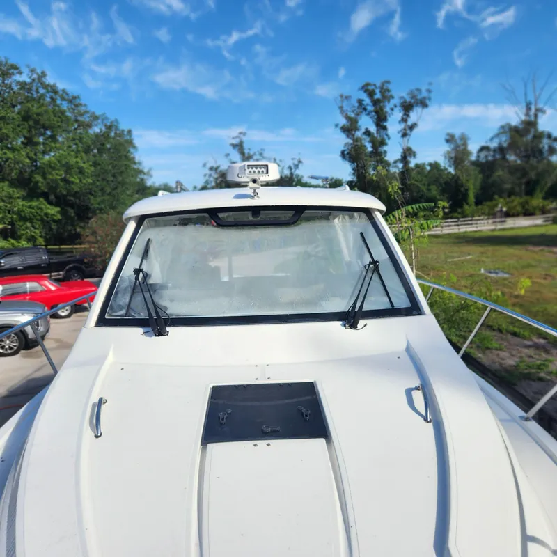 Slide: The Image of 2020 Pursuit OS 325 Offshore boat with windshield wipers and radar, docked outdoors. - 4