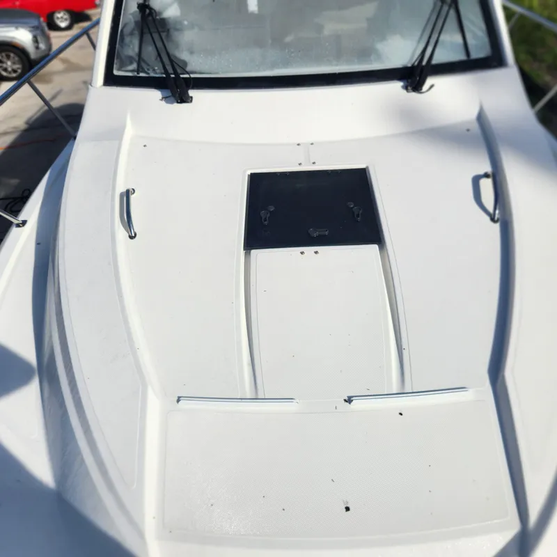 Slide: The Image of 2020 Pursuit OS 325 Offshore boat deck with windshield and hatch. - 5