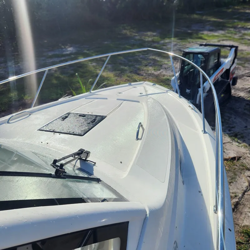 Slide: The Image of 2020 Pursuit OS 325 Offshore boat deck with a loader in the background. - 7