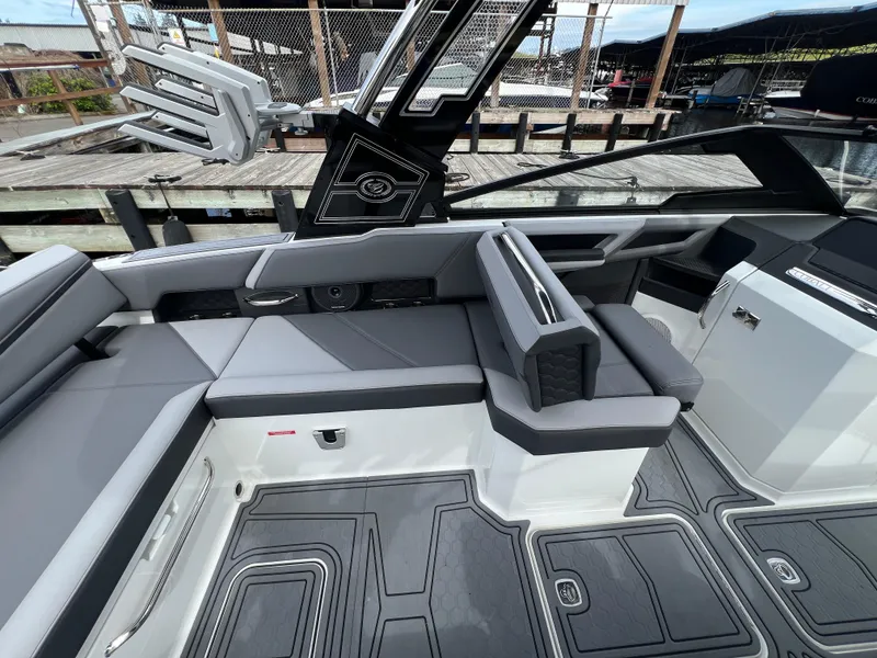 Slide: The Image of 2024 Cobalt R6 Surf boat interior with sleek gray seating and modern design. - 11