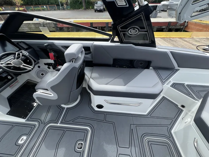 Slide: The Image of 2024 Cobalt R6 Surf boat interior with sleek gray seating and modern dashboard design. - 13