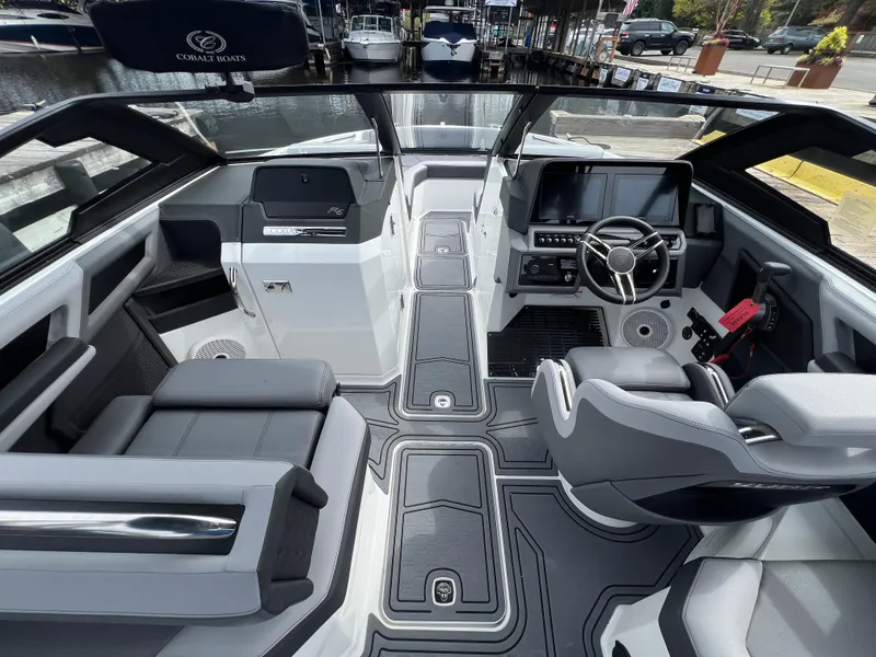 Slide: The Image of 2024 Cobalt R6 Surf boat interior with modern dashboard and seating. - 14