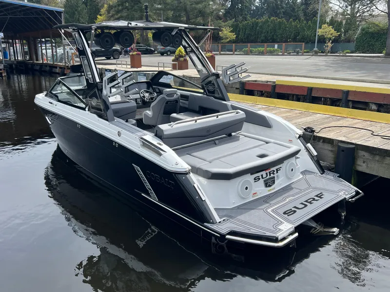 Slide: The Image of 2024 Cobalt R6 Surf boat docked, showcasing sleek design and modern features. - 7