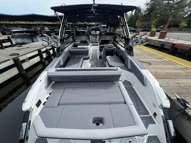 Slide: The Image of 2024 Cobalt R6 Surf boat docked, featuring spacious seating and modern design. - 9